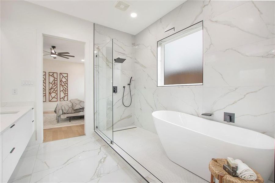 Bathroom with vanity, ceiling fan, and shower with separate bathtub