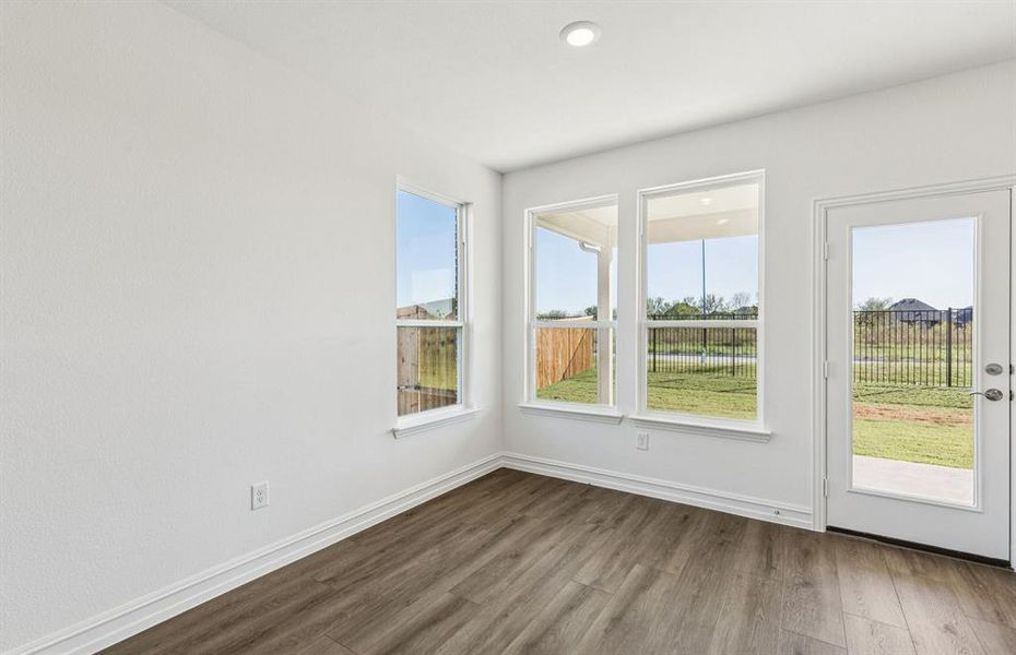Dining nook off kitchen with large windows Dining nook off kitchen with large windows