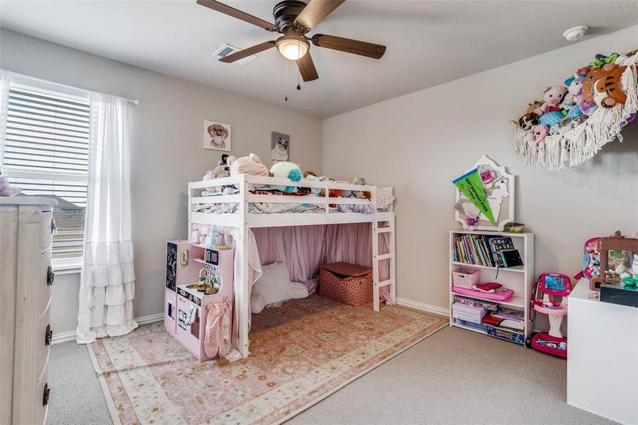 Bedroom with a ceiling fan and light carpet Bedroom with a ceiling fan and light carpet