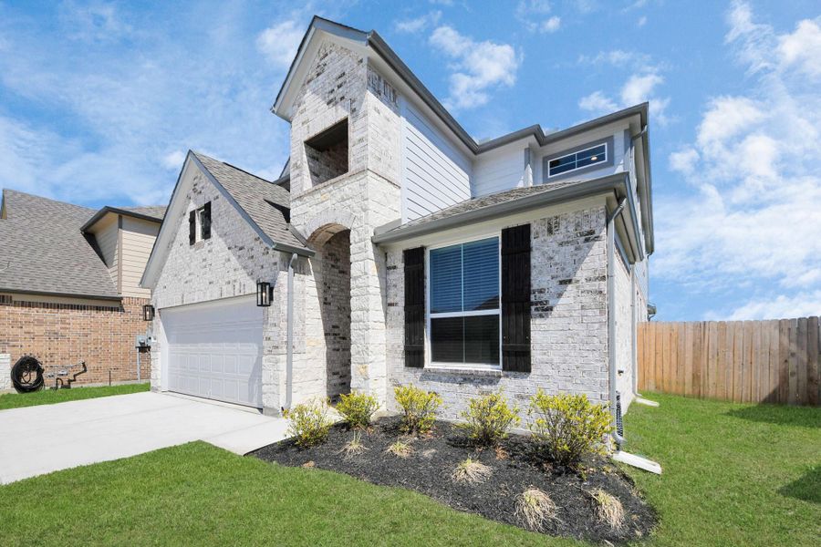 Behold a lush landscape, impeccably maintained yard, and a premium elevation adorned with captivating brick and stone features. Behold a lush landscape, impeccably maintained yard, and a premium elevation adorned with captivating brick and stone features.