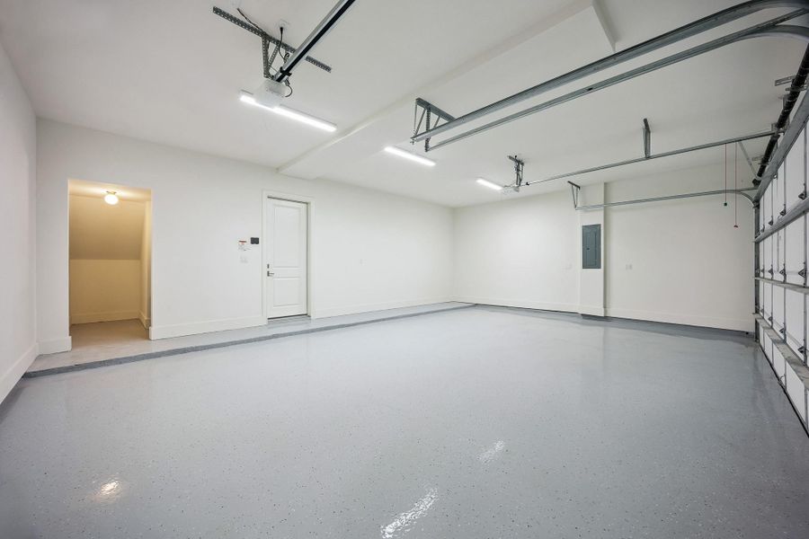 Immaculate enough to eat off the floor, this oversized three-car garage features epoxy-coated flooring and excellent storage potential.