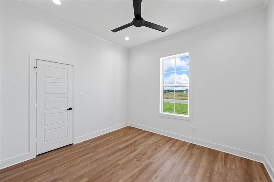 Unfurnished room featuring ornamental molding, light wood-style flooring, recessed lighting, and a ceiling fan