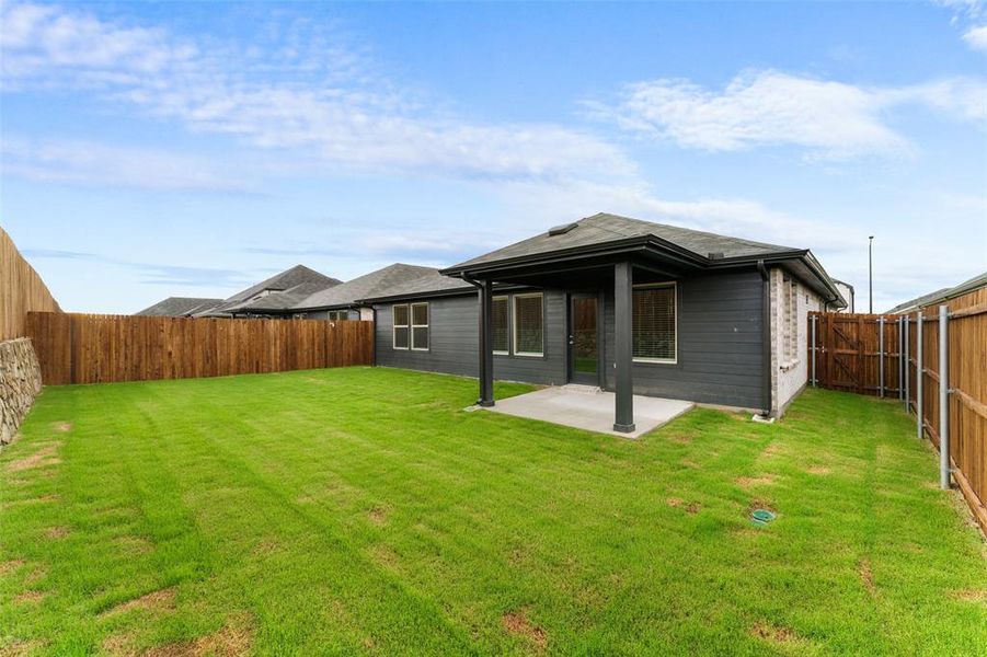 Back of house featuring a patio area, a fenced backyard, and a shingled roof Back of house featuring a patio area, a fenced backyard, and a shingled roof