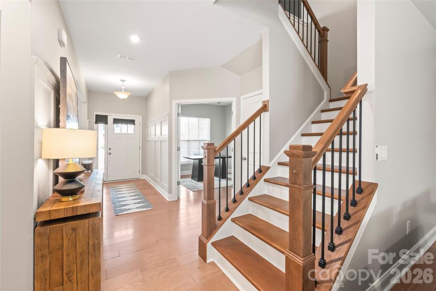 Extra-wide stairs with elegant wrought iron railing.