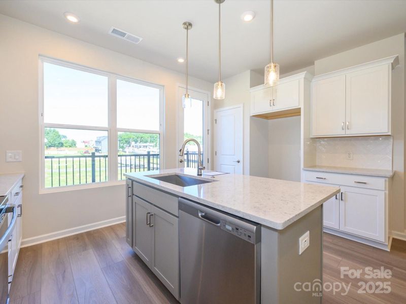 Contrasting cabinet colors at the island adds design interest.