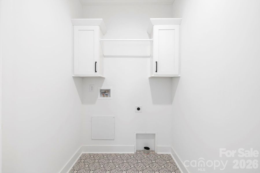 Main Level Laundry w/ door to hall & Primary Suite