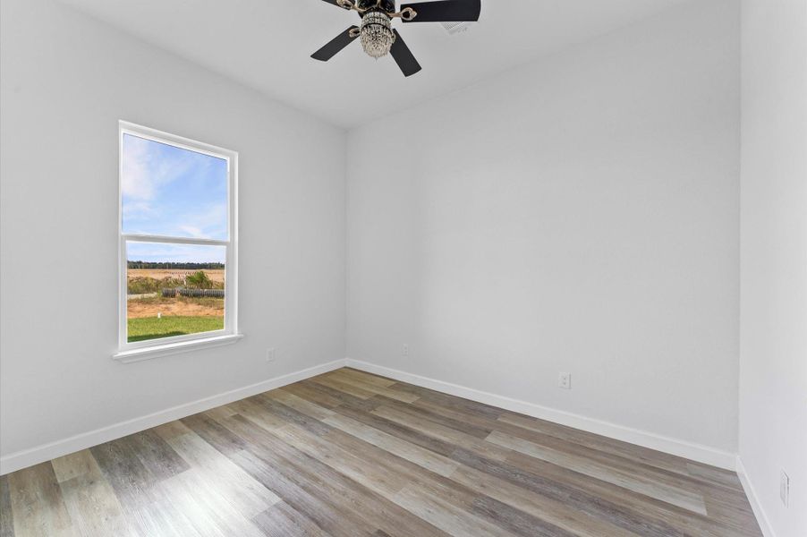 Secondary bedroom with laminate floors (no carpet), generous closet, and bright natural light. Secondary bedroom with laminate floors (no carpet), generous closet, and bright natural light.