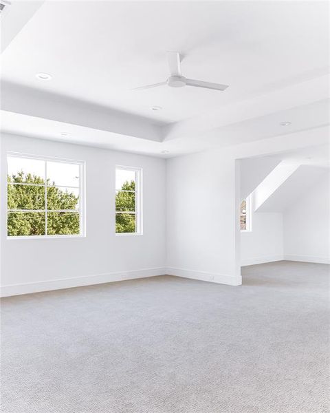 Spare room with light colored carpet and ceiling fan