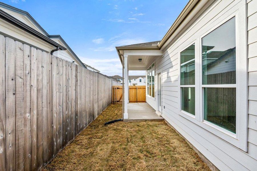 Fenced backyard with a patio