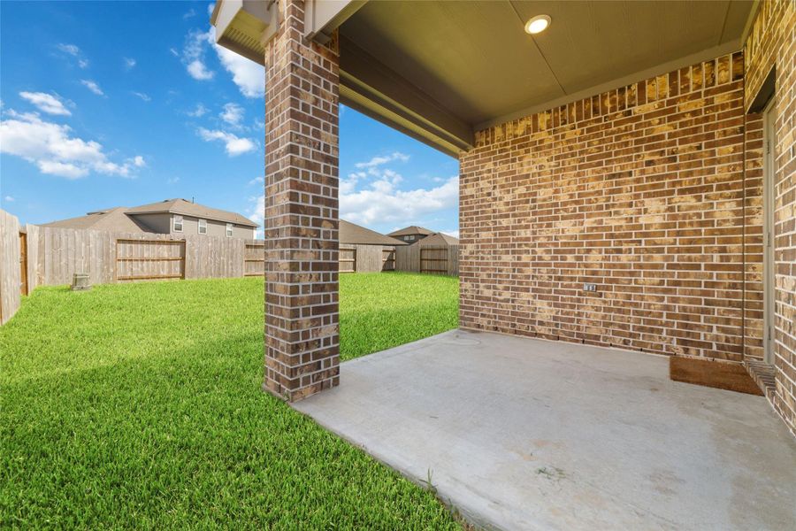 Exterior details and patio area of a home in Sunterra, Katy (Image 22).