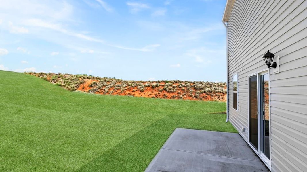 Exterior details and patio area of a home in Durbin Meadows Traditions, Fountain Inn (Image 18).
