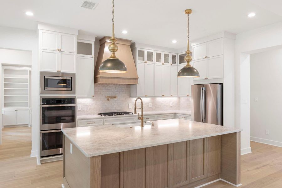 Beautiful and timeless custom designed kitchen with stainless steel appliances and a gas cooktop. Beautiful and timeless custom designed kitchen with stainless steel appliances and a gas cooktop.