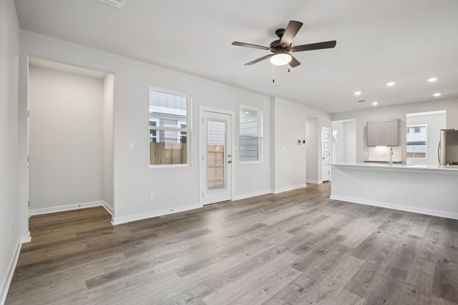 A room with white walls and a ceiling fan.