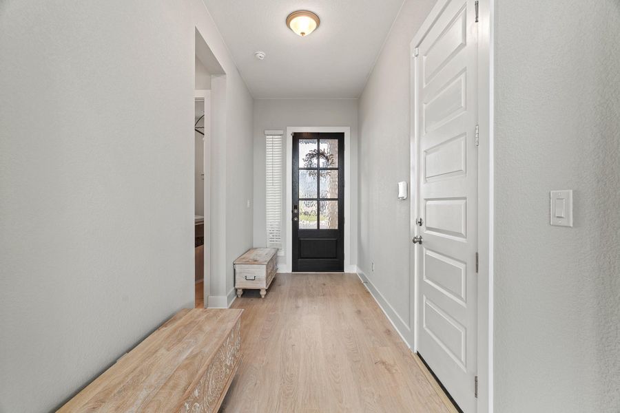 Doorway with wood finished floors and baseboards Doorway with wood finished floors and baseboards