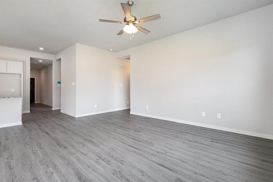 Spare room with ceiling fan and wood-type flooring