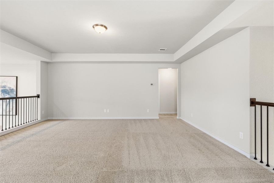 Enter your expansive upstairs game room offers endless possibilities for a media lounge, playroom, home gym, or second living area, with open views overlooking the main level.