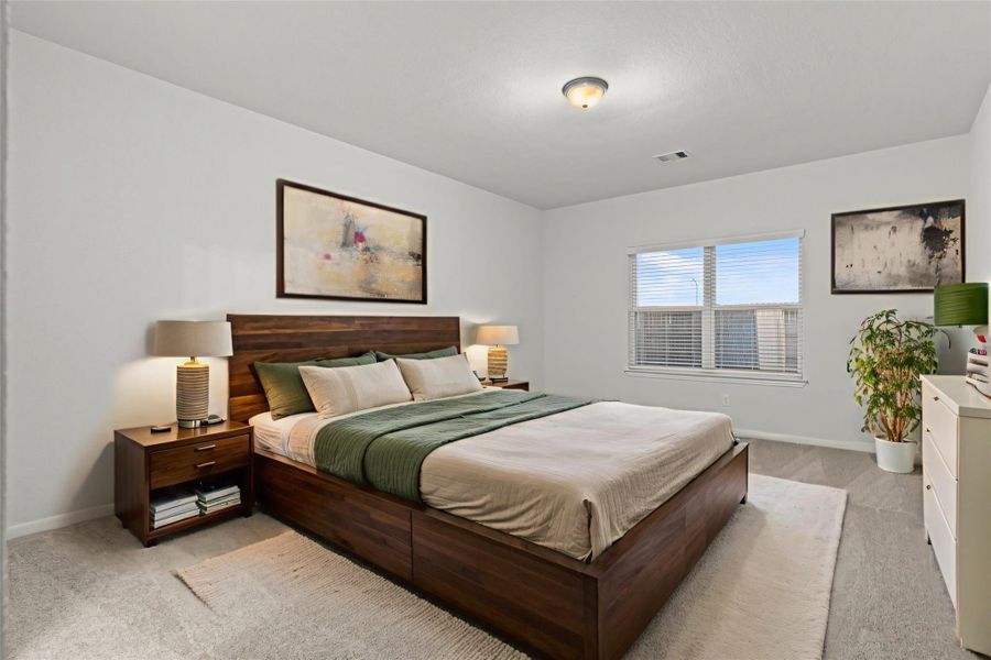 The virtually staged primary bedroom offers a relaxing retreat with soft natural light and ample space for your favorite furnishings. Plush carpeting and a soothing color palette create the perfect environment for rest and comfort.