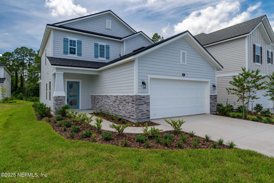 Front exterior of a new home in Beacon Lake, St. Augustine, FL, highlighting curb appeal (Image 36).