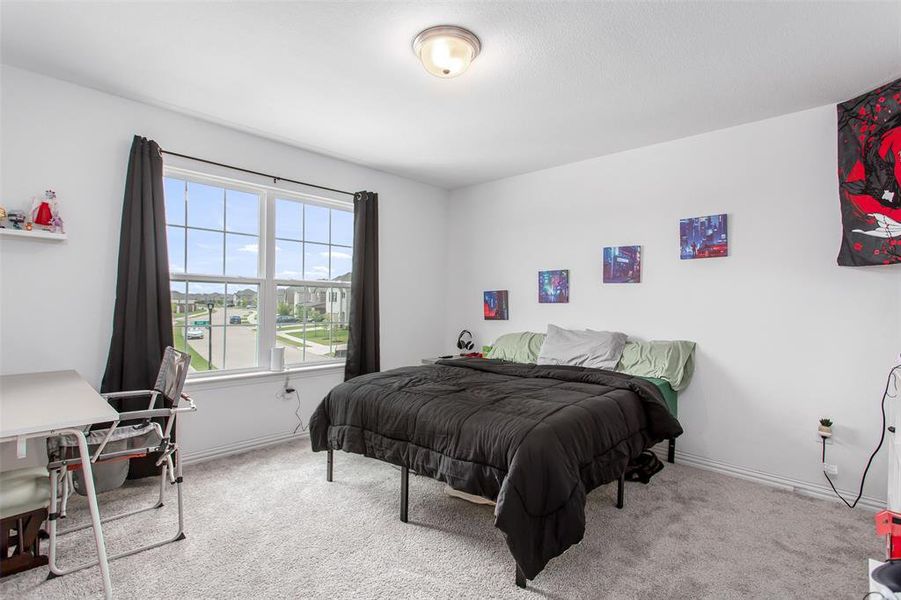 Carpeted bedroom featuring baseboards