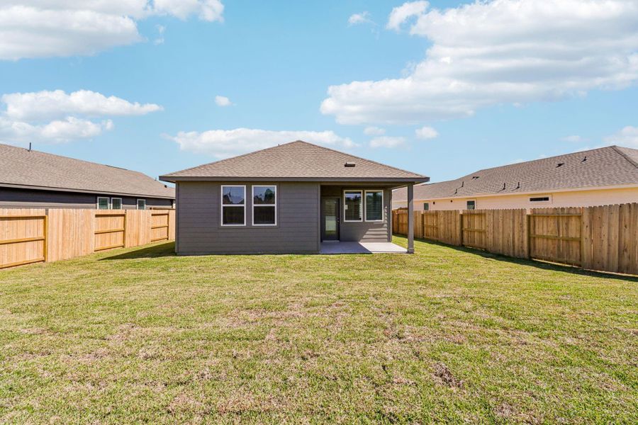 Exterior details and patio area of a home in Granger Pointe - Traditional Series, New Caney (Image 27).