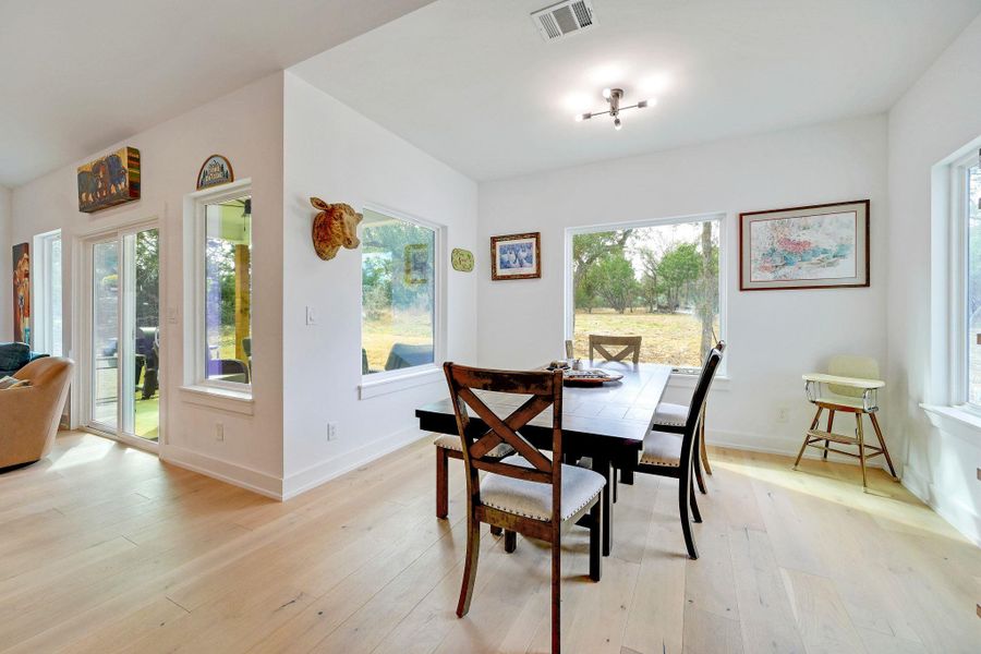 Dining area with light wood-type flooring and baseboards