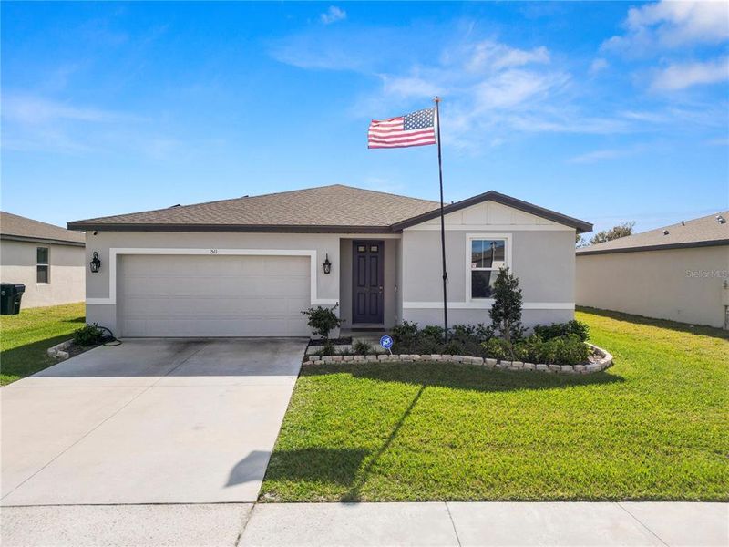 Front exterior of a new home in The Reserve at Van Oaks, Auburndale, FL, highlighting curb appeal (Image 1). Front exterior of a new home in The Reserve at Van Oaks, Auburndale, FL, highlighting curb appeal (Image 1).