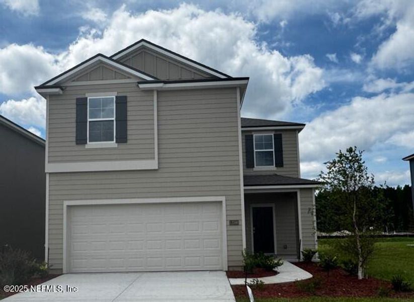 Front exterior of a new home in The Arbors, Jacksonville, FL, highlighting curb appeal (Image 25). Front exterior of a new home in The Arbors, Jacksonville, FL, highlighting curb appeal (Image 25).