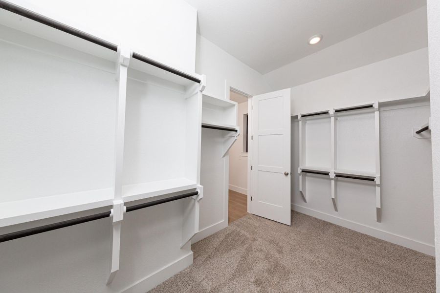 Look at this immaculate closet! With high shelving, multiple rows to hang clothing, you are sure to have enough room for all your belongings! The primary closet has access to the laundry room for convience!