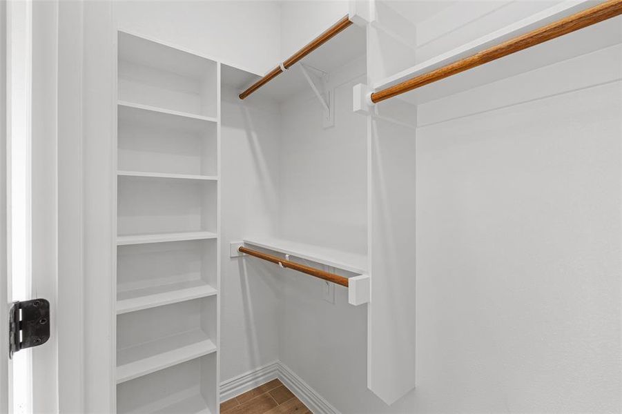 Spacious closet with hardwood / wood-style floors