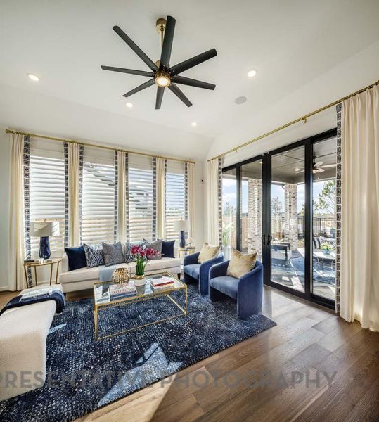 Living room with a ceiling fan, wood finished floors, healthy amount of natural light, and recessed lighting Living room with a ceiling fan, wood finished floors, healthy amount of natural light, and recessed lighting