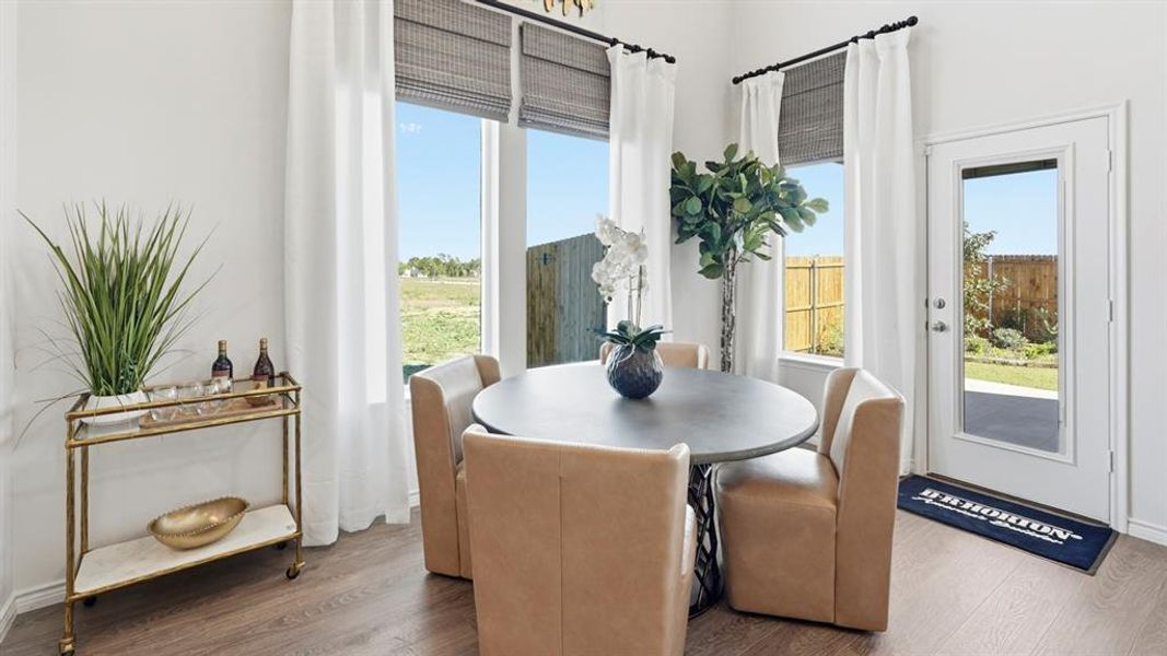 Dining area featuring dark wood-style floors