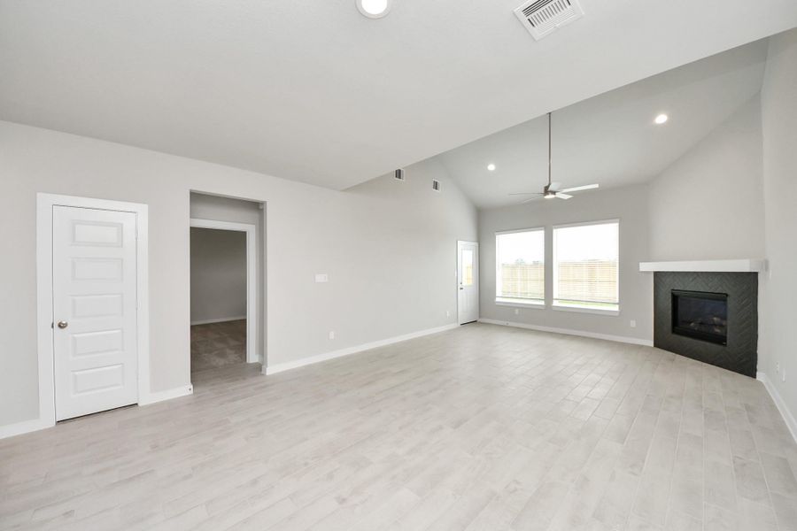 Relax and unwind in this inviting family room, illuminated by abundant natural light streaming in through tall windows, complemented by high ceilings and stunning flooring. Stay comfortable year-round with the gentle breeze from the ceiling fan, creating the perfect atmosphere for family gatherings. Sample photo of completed home with similar floor plan. Actual colors and selections may vary. Relax and unwind in this inviting family room, illuminated by abundant natural light streaming in through tall windows, complemented by high ceilings and stunning flooring. Stay comfortable year-round with the gentle breeze from the ceiling fan, creating the perfect atmosphere for family gatherings. Sample photo of completed home with similar floor plan. Actual colors and selections may vary.