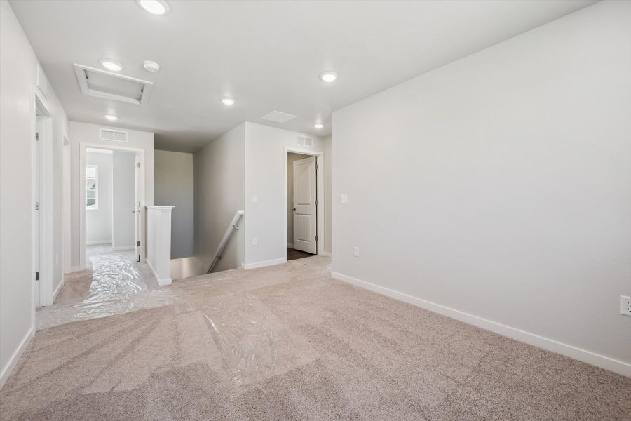 A hallway with white walls.