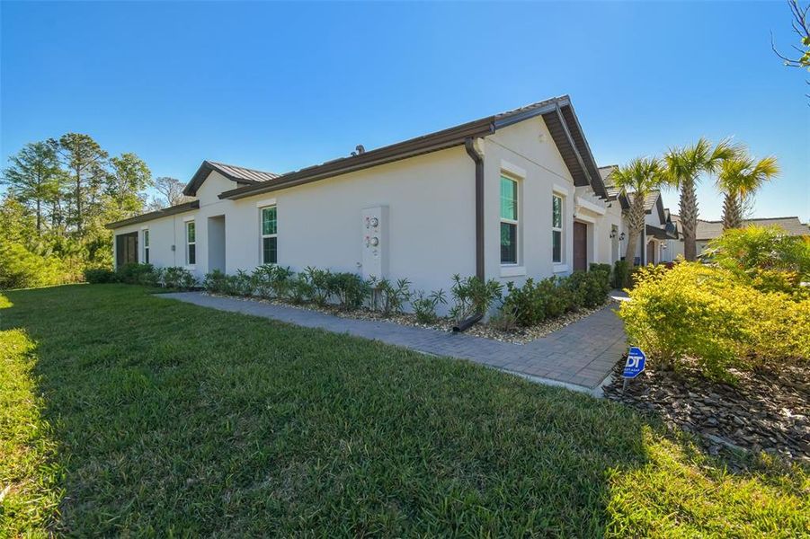Front exterior of a new home in Angeline Active Adult, Land O' Lakes, FL, highlighting curb appeal (Image 25).