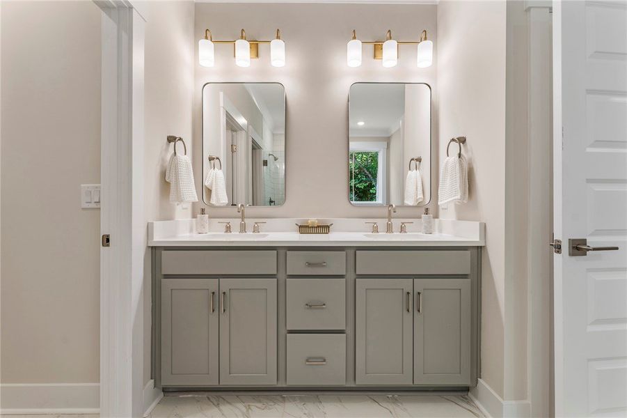 This modern bathroom features a double vanity with This modern bathroom features a double vanity with