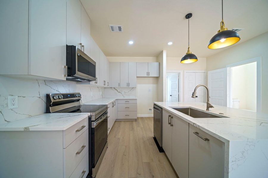 Bright and airy kitchen with ample natural light. Bright and airy kitchen with ample natural light.