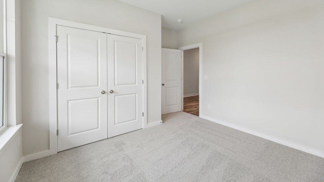 Secondary Bedroom with carpet and closet Secondary Bedroom with carpet and closet