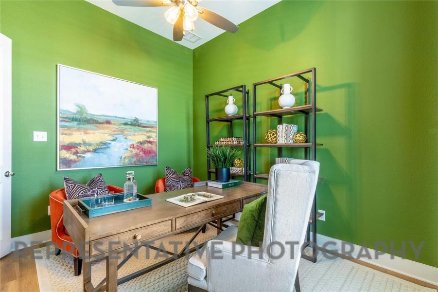 Office featuring baseboards, a ceiling fan, wood finished floors, and visible vents Office featuring baseboards, a ceiling fan, wood finished floors, and visible vents