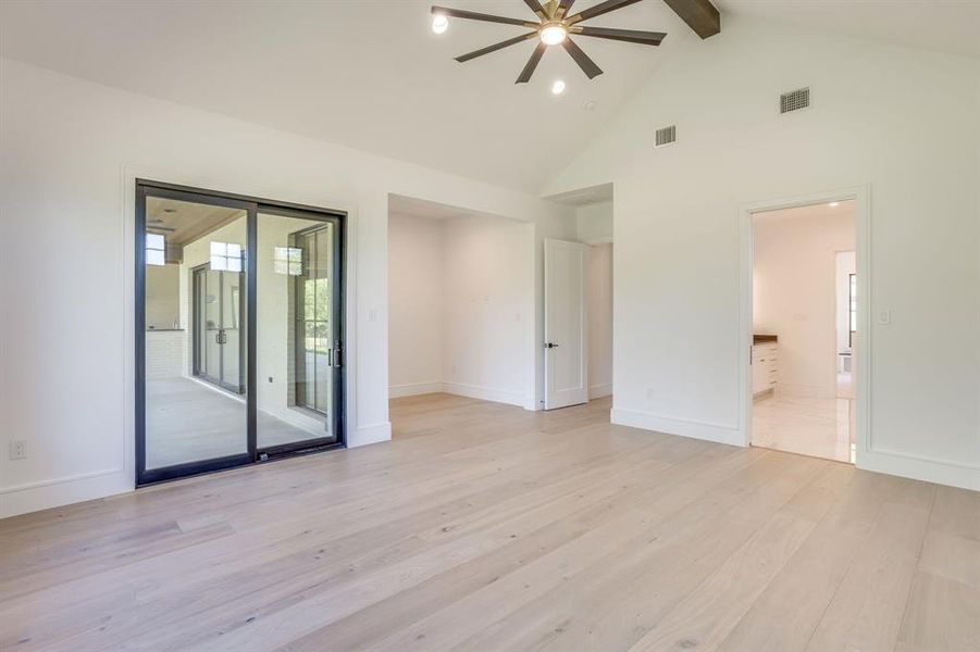 Unfurnished bedroom featuring light wood finished floors, a ceiling fan, access to outside, and ensuite bathroom