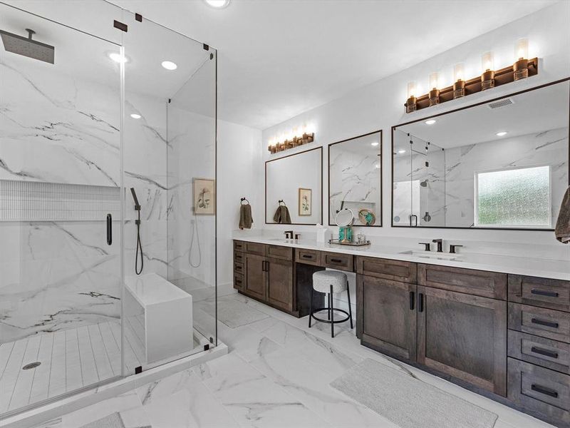 The shower and double sink located in the primary bath.