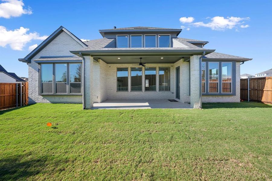 Rear view of property featuring a ceiling fan, a fenced backyard, a patio, brick siding, and a shingled roof Rear view of property featuring a ceiling fan, a fenced backyard, a patio, brick siding, and a shingled roof