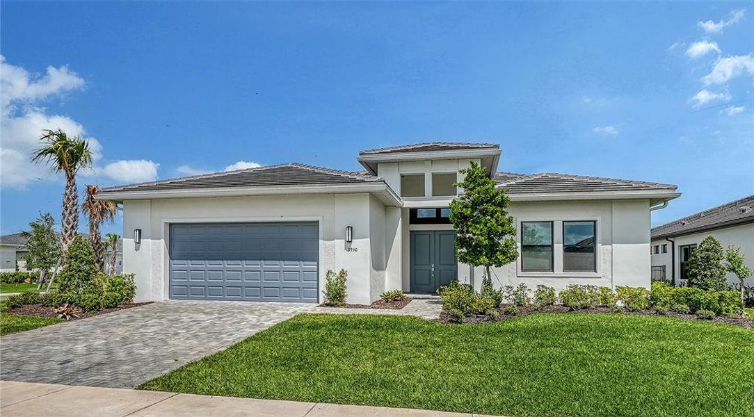 Front exterior of a new home in Artistry Sarasota, Sarasota, FL, highlighting curb appeal (Image 26).