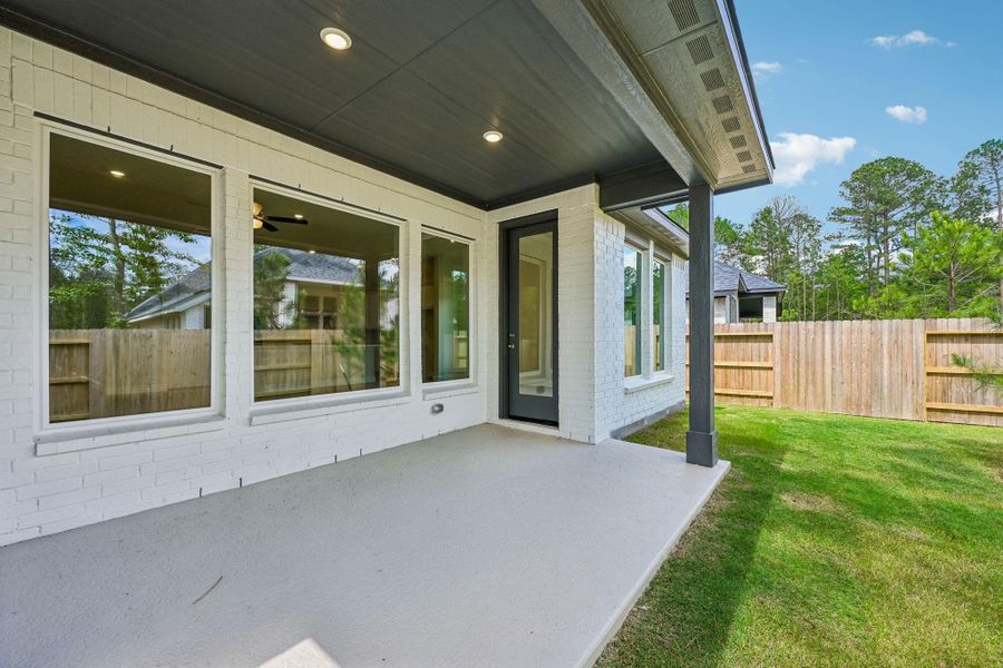 Exterior details and patio area of a home in Woodhavyn 50', Magnolia (Image 3).