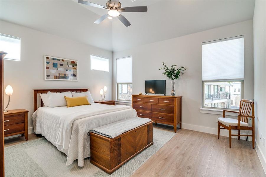 The master bedroom is at the rear of the home and includes more large windows with top-down, bottom-up blinds.