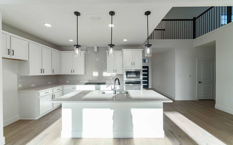 Kitchen with appliances with stainless steel finishes, light countertops, decorative backsplash, white cabinets, and recessed lighting