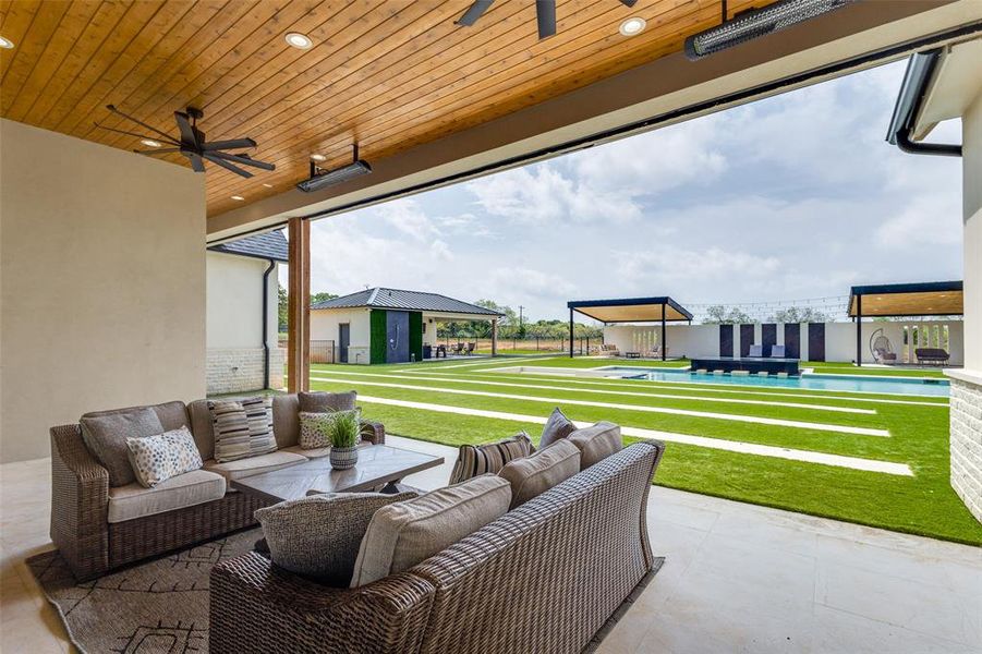 View of terrace featuring an outdoor living space and ceiling fan