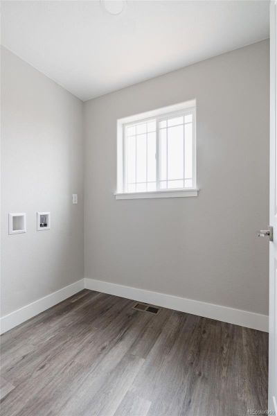 large laundry room located close to the bedrooms with a bright window and so much space