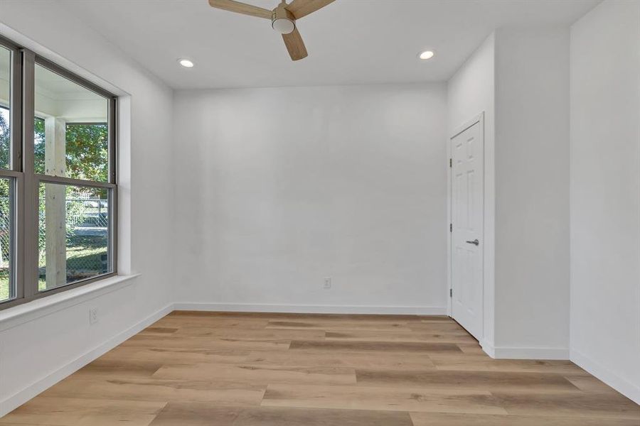 Spare room featuring light wood-type flooring, recessed lighting, and a ceiling fan
