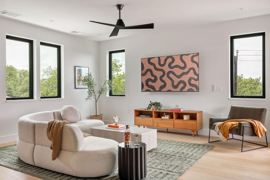 Living area with light wood-type flooring and ceiling fan Living area with light wood-type flooring and ceiling fan