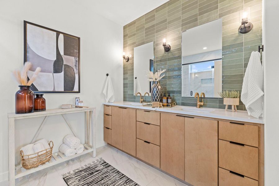 Bathroom featuring double vanity and light marble finish flooring
